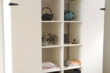 IKEA Kallax pieces turned into a large storage unit wiht added doors, with crates and decor is a creative idea