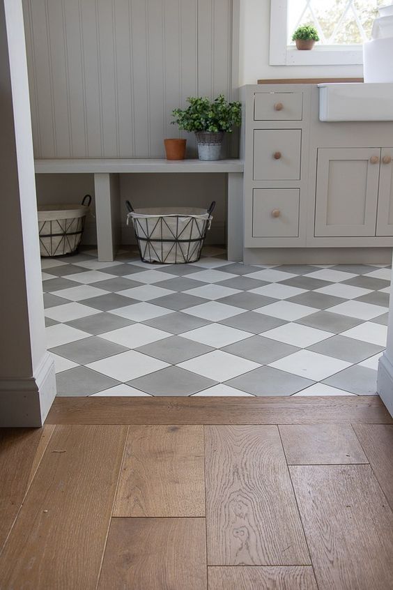 a checked tile floor and a laminate floor with a boundary of wood look quite cohesive and stylish