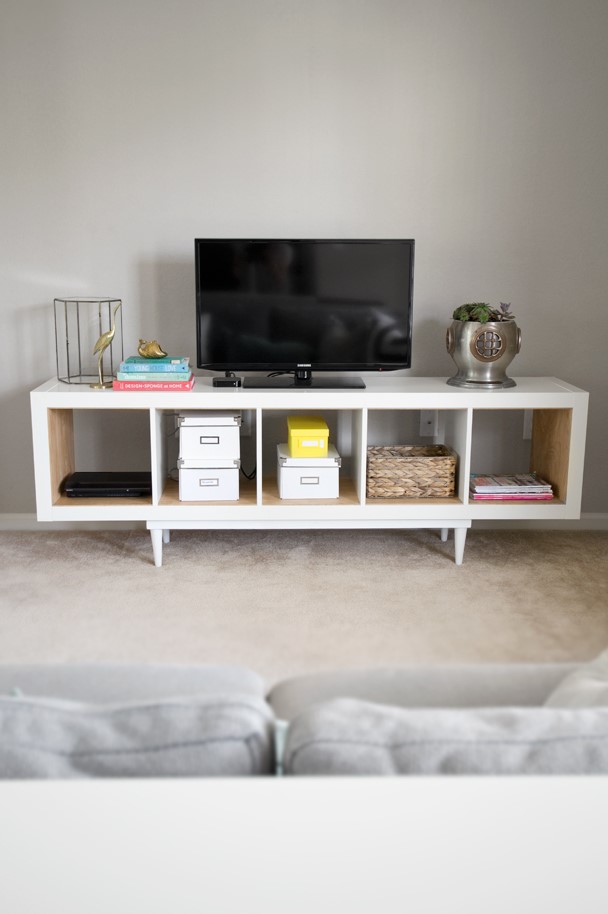 a lovely TV stand made of an IKEa Kallax piece, with additional legs and stained wood inside each compartment is a cool idea