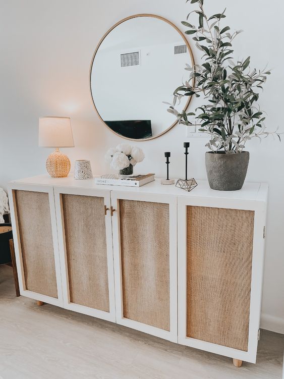 a lovely credenza or console of an IKEA Kallax piece with cane doors and with wooden legs is a lovely idea for a Scandinavian space