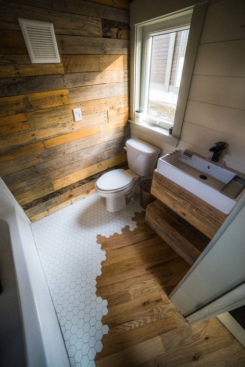 a modern cabin powder room with reclaimed wood and a hex tile floor, a wall-mounted vanity with a sink is cool