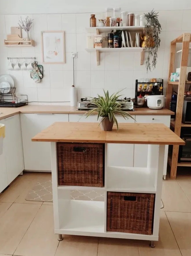 a neutral bohokitchen with a small kitchen island of an IKEA Kallax piece finished off with woven drawers is a lovely space