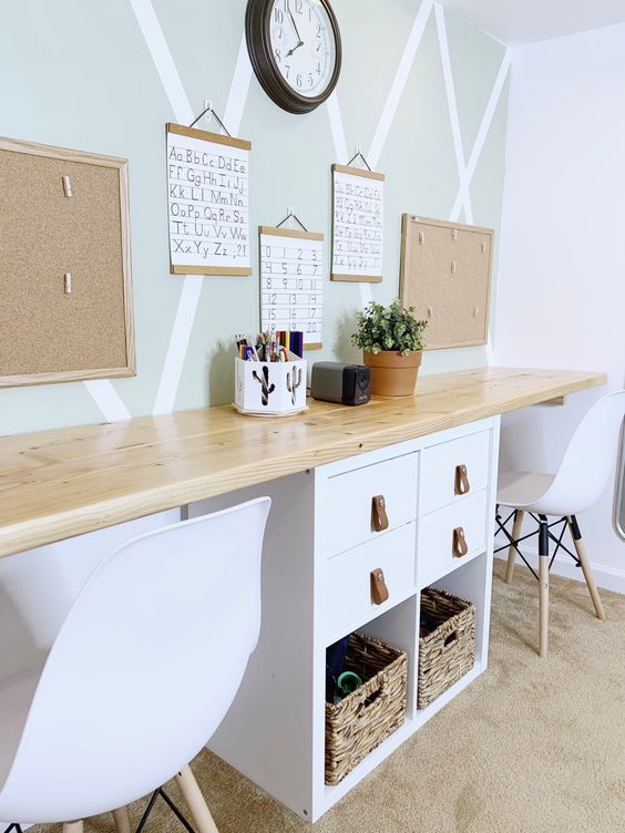 a shared desk of an IKEA Kallax piece with drawers and baskets and with a long butcherblock countertop is a cool idea for a kids' space