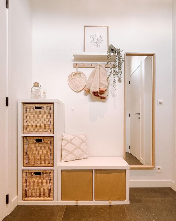 a small boho entryway with a couple of Kallax units finished with drawers that provide the space with storage