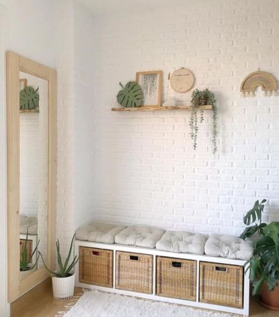 a small storage bench of an IKEA Kallax unit with woven drawers and soft cushions is a cool idea for an entryway