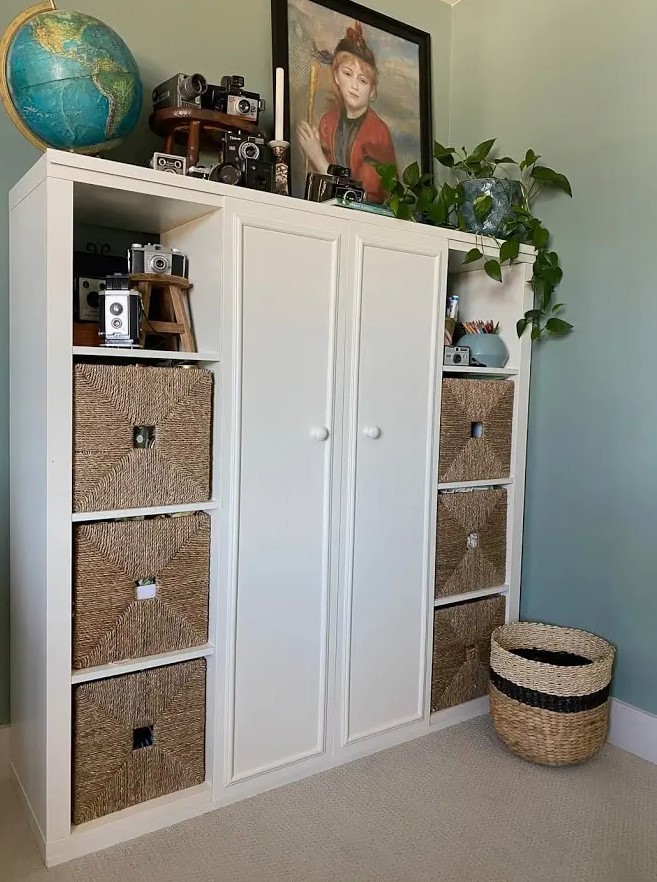 an IKEA Kallax piece with doors and woven drawers, with decor on top is a great storage solution for many spaces