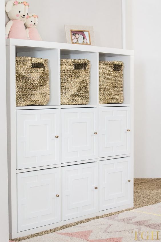 an IKEA Kallax piece with woven baskets and geometric doors is a pretty and cool dresser for a kids' room