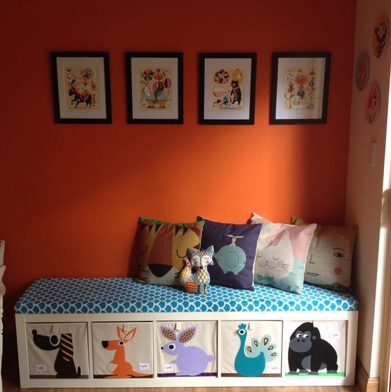an Ikea Expedit playroom bench made of fabric stuffed with foam and sprouts storage cubes