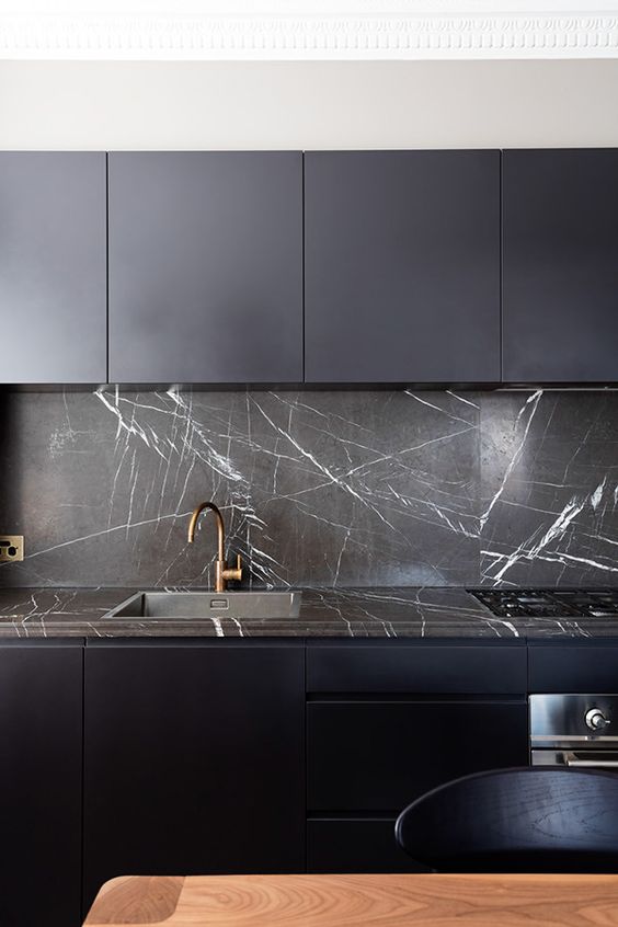 black modern kitchen with dark marble kitchen backsplash