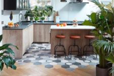 a cool wood and tile transition on a contemporary kitchen with retro elements