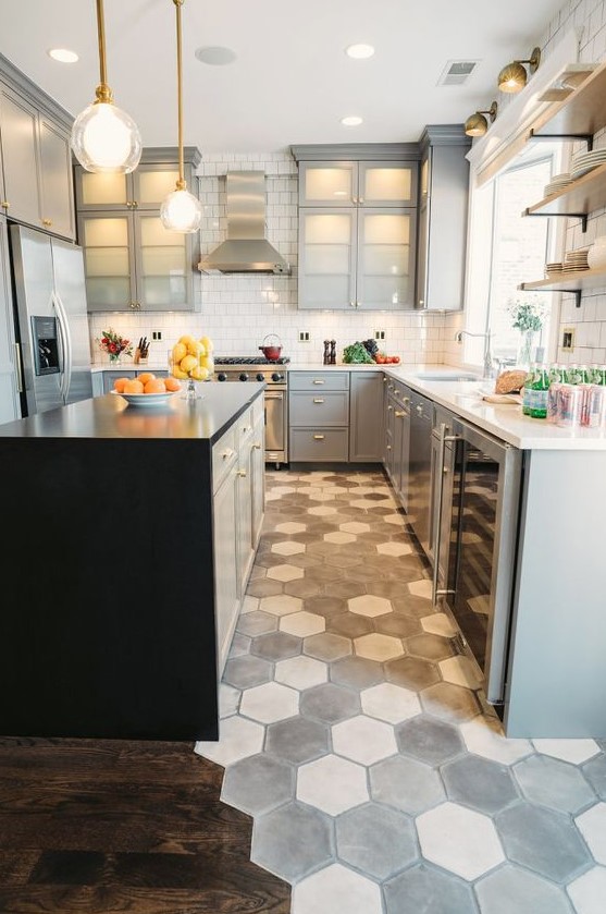 grey and white hex tiles in the cooking zone contrast the dark laminate