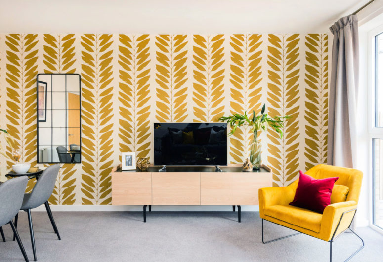 a living room with bright yellow walls and minimalist carpet flooring