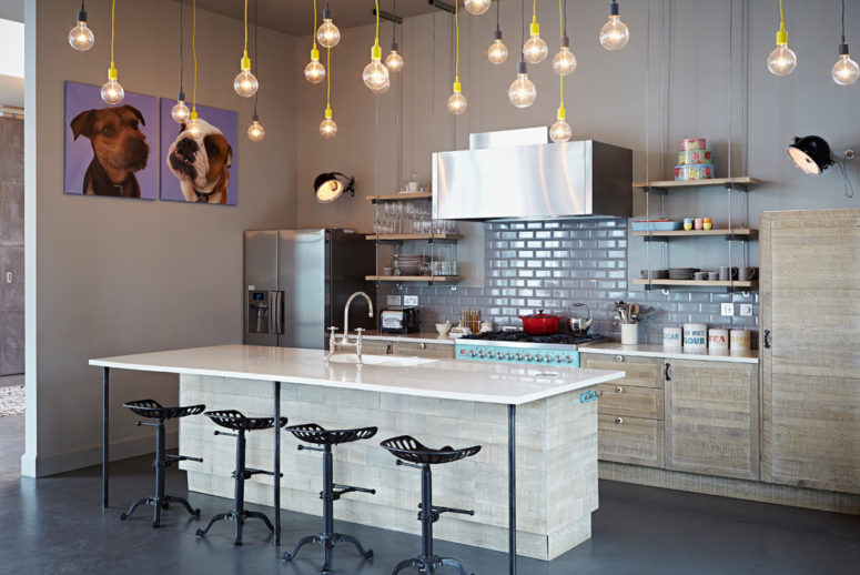 dark gray concrete flooring looks great under whitewashed wood kitchen cabinets (Godrich Interiors)