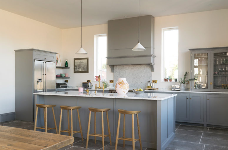 grey flooring even works with grey kitchen cabinets (Floors of Stone)