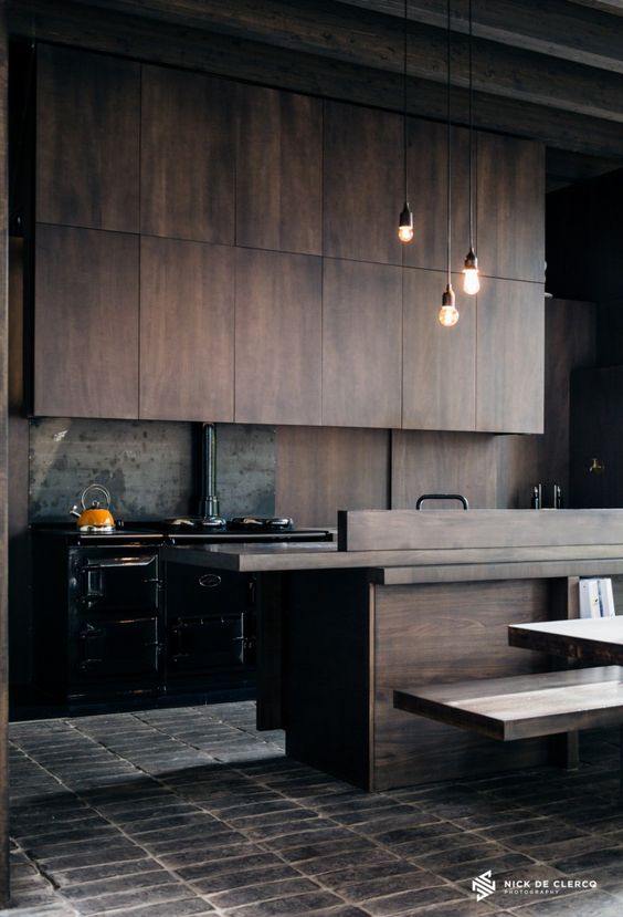 https://www.digsdigs.com/photos/2016/07/moody-industrial-style-kitchen-with-timber-cabinets-and-a-black-freestanding-cooker.jpg