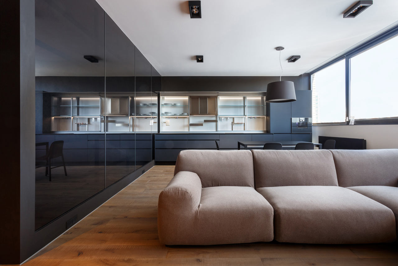 01 This minimalist bachelor’s pad was designed using moody colors and warm woods