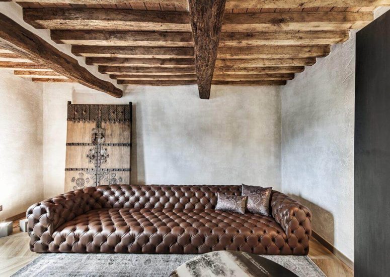 This unique house is located in Italy and perfectly blends rustic style with artful rough touches that make the interiors refined