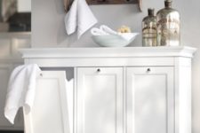 tilt-out laundry hampers in neat white drawers