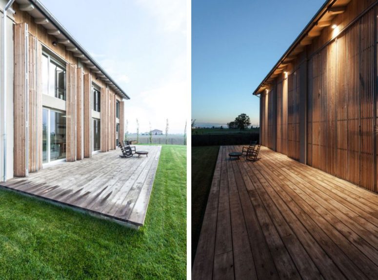 The wooden deck and perfectly manicured lawn extend living spaces, providing opportunities for spending time outdoors