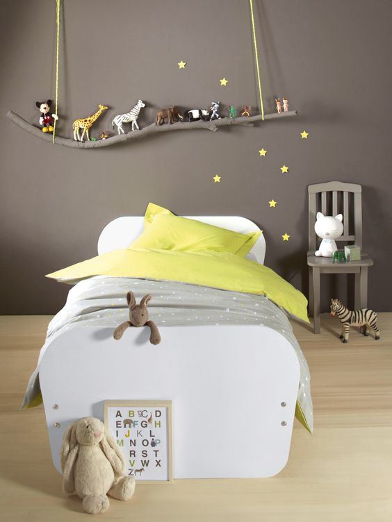 grey boy's sleeping area with a branch toy shelf over the bed