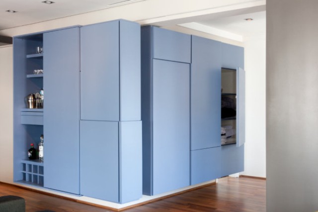 The sliding door slides into a slot within the box to form a cubic wall sculpture seen from the living room side The sliding door slides into a slot within the box to form a cubic wall sculpture seen from the living room side