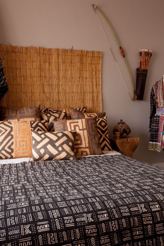 This calm bedroom boasts of a cool headboard and warm colored traditional texiles that remind of Africa