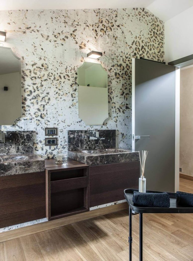In this bathroom you can see wallpaper with leopard prints