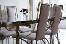 05 The dining space looks amazing with blush chairs and a modern gold and silver dining table