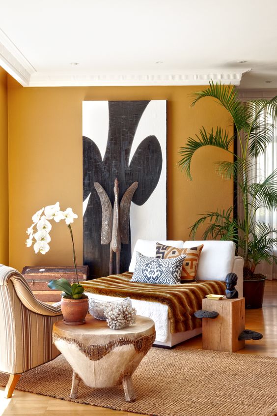 Shades of ocher, carvings of wood and the artworks make this living room terrific