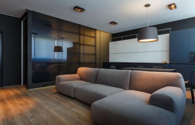 The plush, L-shaped sofa in a neutral color is by Paola Lenti