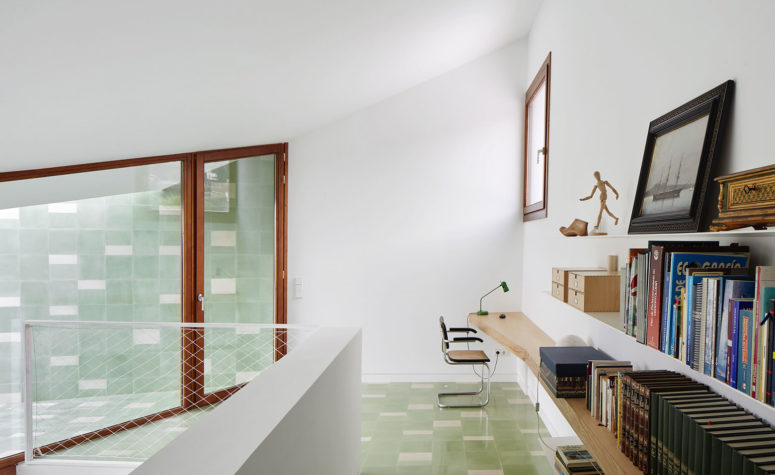 White walls are complemented by timber details, in window frames and doors
