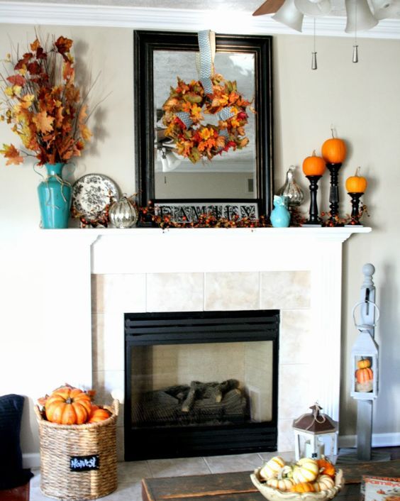 fall leaf wreath and bouquet in a vase, pumpkins on stands and a large framed mirror fall leaf wreath and bouquet in a vase, pumpkins on stands and a large framed mirror