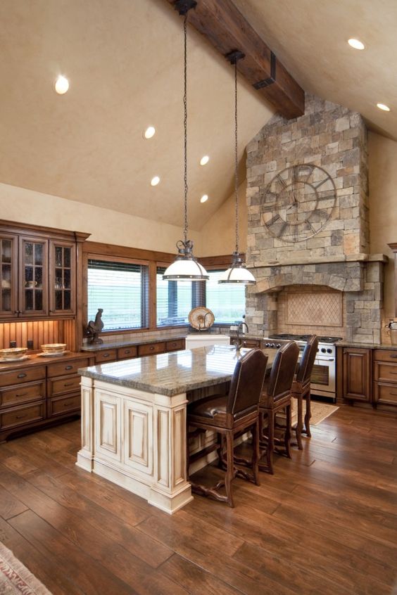 two-toned wooden floor and brushed wooden island really give this space a rustic atmosphere