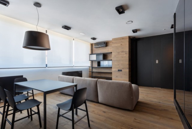 The living room area is almost fully clad with warm woods to make it cozier