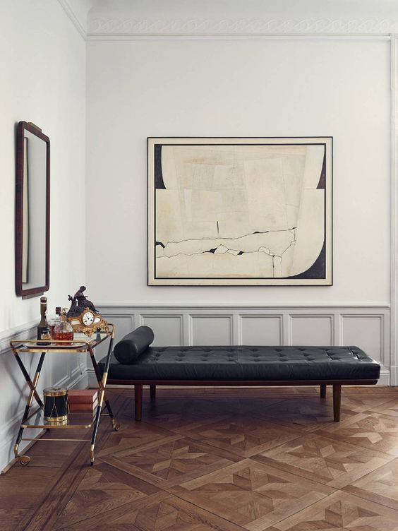 chic art deco living room with low grey wainscoting to give volume to the walls