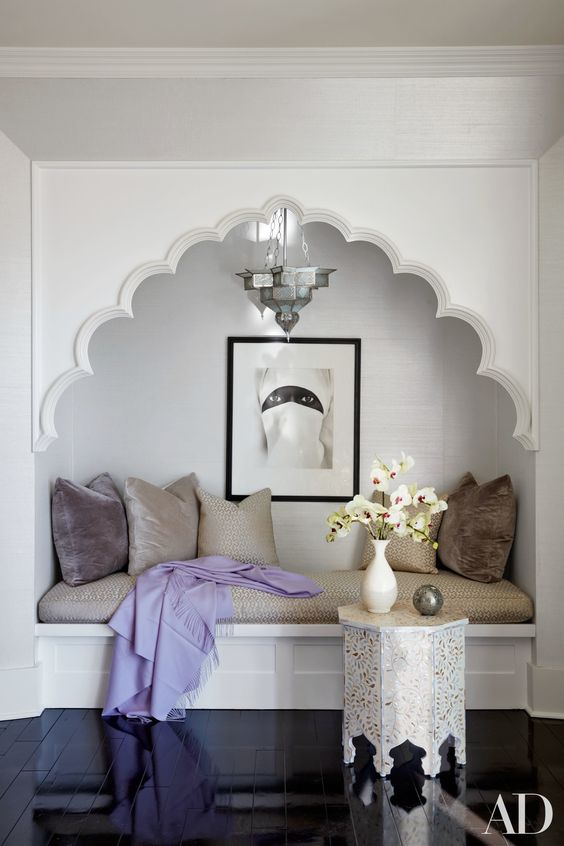 reading nook with an upholstered bench and a Moroccan arch