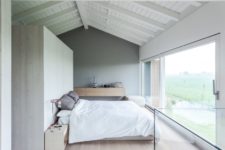 09 The master bedroom is decorated around the views of nature outside, such a light and dreamy space