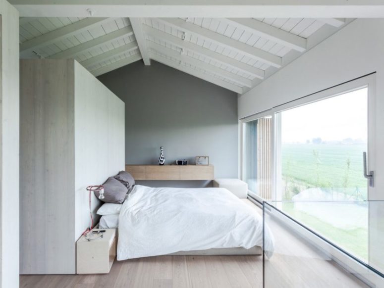 The master bedroom is decorated around the views of nature outside, such a light and dreamy space