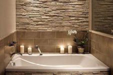 09 stone accent wall and bathtub decor in earthy colors