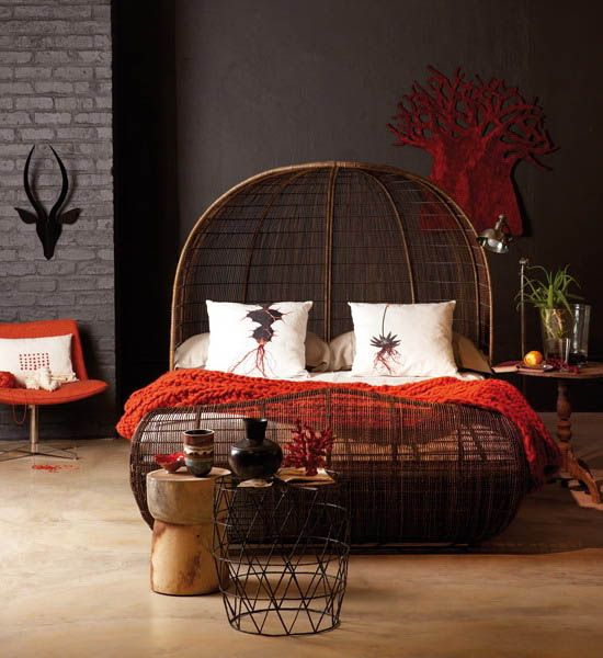 Dark woven bed and matching side tables of wood and metal