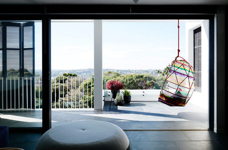 There's a large terrace with a colorful hanging chair