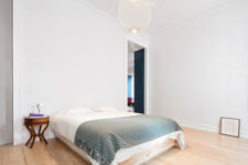 12 The master bedroom is clean and uncluttered, with colorful textiles and a cool hanging lamp