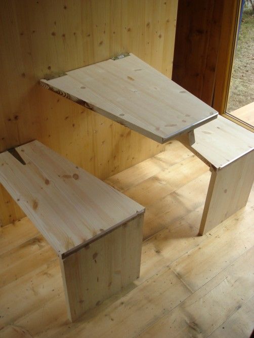 breakfast nook with wall-mounted stools and a foldable table