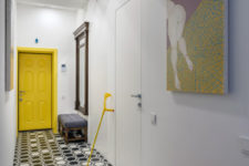 13 The hallway is bold and colorful, with creative geo tiles and the owner’s art piece