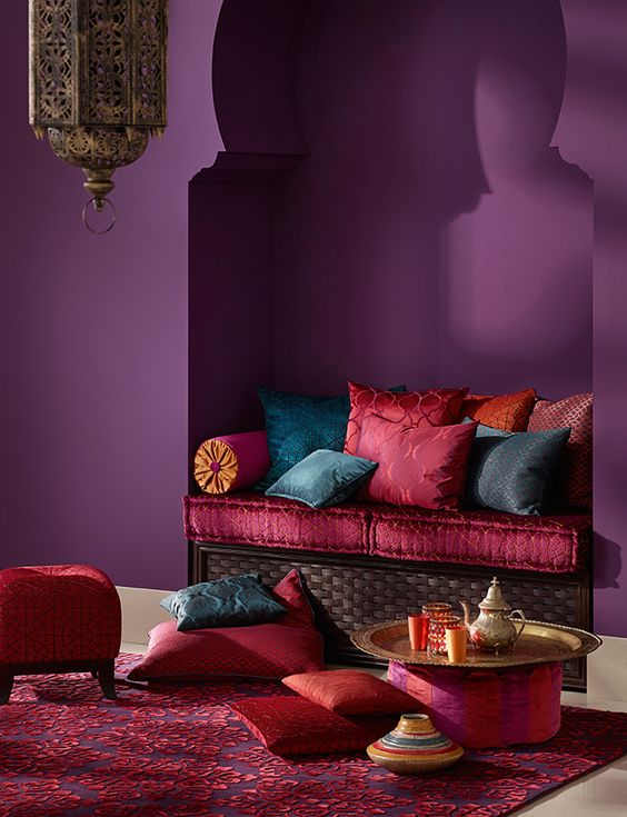a nook decorated in dark purple, hot red and pink colors