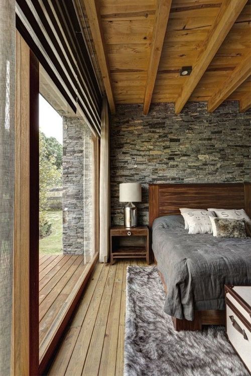 dark grey headboard wall contrasts with warm woods