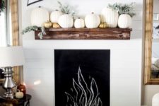 16 faux mantel with pumpkins and a fabric wall decoration