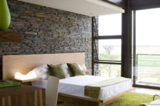 16 ultra-modern bedroom with a stone wall that gives texture to the room
