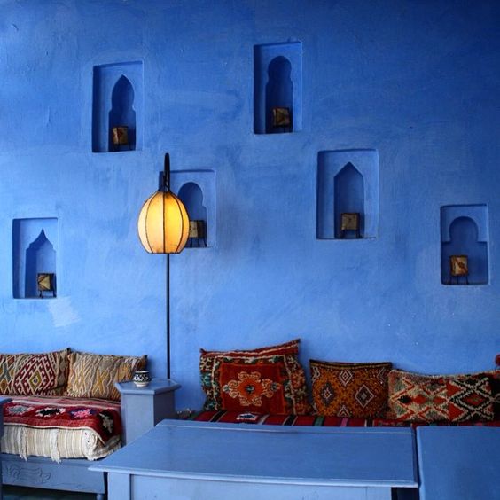 blue walls with niche lanterns and bright textiles