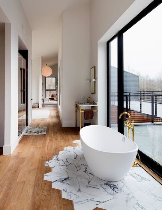 marble-printed tiles only under the bathtub to prevent wooden floors from water damage
